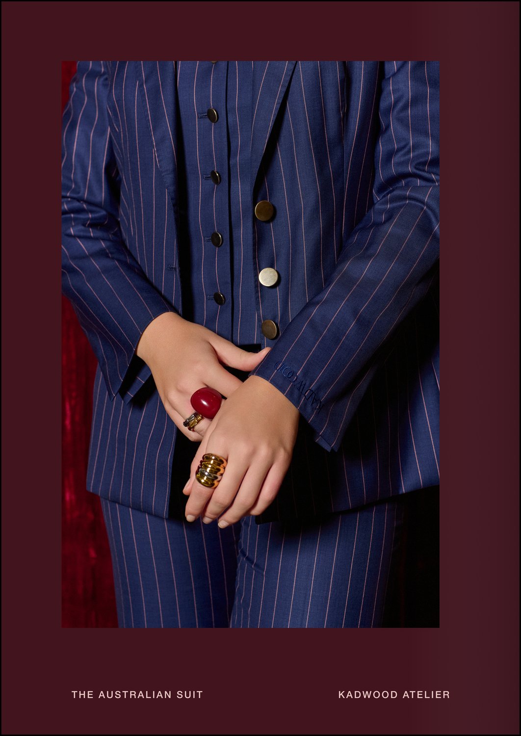 Close up of signature KADWOOD cuff embroidery on The Australian Suit in Twilight Blue-Red Guarded Stripe by Holland & Sherry, bespoke made to measure in 100 percent Australian Merino wool for executive women at Kadwood Atelier—the premier women’s tailor and global leader in sustainable suit design.