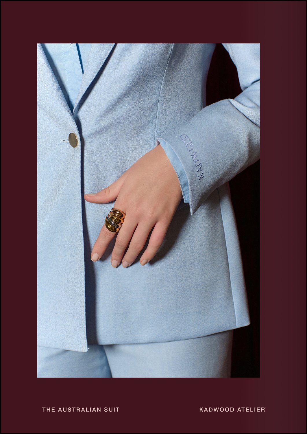 Close up of an embroidered KADWOOD cuff and soft subtle shine of pastel blue faille weave on The Australian Suit showcasing fine Merino wool craftsmanship and Kadwood Atelier’s mission to elevate and connect women through tailored artistry