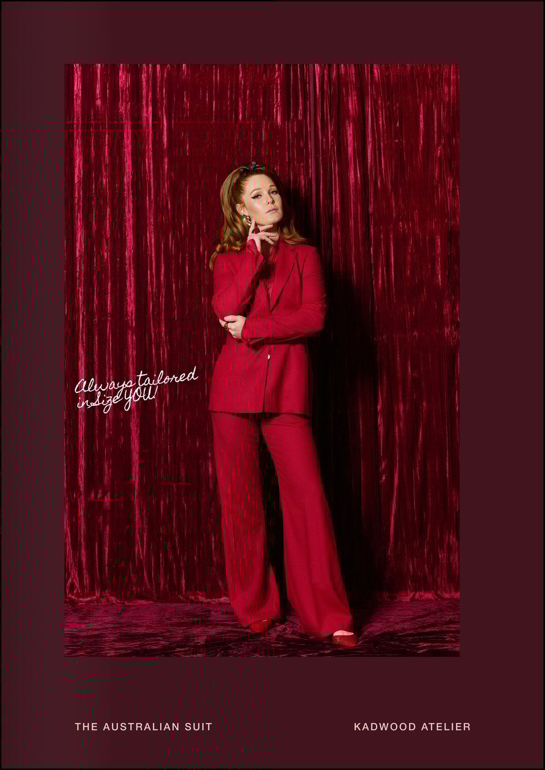 Three quarter view of a model in The Australian Suit crimson crepe power suit designed by Erin Kadwood and crafted sustainably in London and Prague using 100 percent wool crepe for executive women